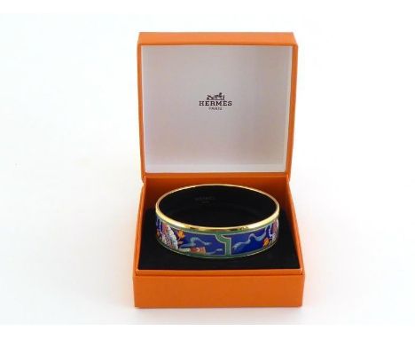 HERMES , an enamel bangle depicting fan motif with gold finish. Stamped HERMES Paris, Made in Austria. With original presenta