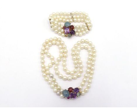 A two strand cultured pearl choker, composed of uniform 6.5mm pearls, to a multigem clasp including aquamarine, tourmaline, a