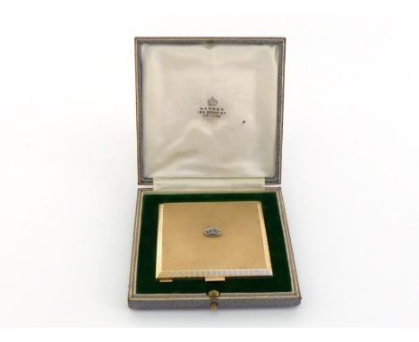 An Art Deco 9 carat gold and diamond powder compact, the square compact engine turned front and verso, with diamond set coron
