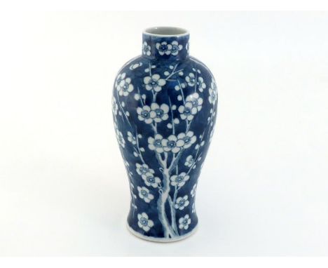 A Chinese porcelain blue and white vase, painted with plum flowers and trees on the body, Kangxi mark to the base, 19th centu