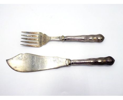 A pair of silver-handled fish servers of near Chippendale pattern, by William Yates Ltd., Sheffield, 1921/24, with plated bla