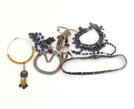 A  mixed lot of Eastern white metal necklaces, including one set with amber, a lapis lazuli example, a polychrome enamel exam