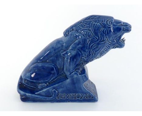 A blue glazed ceramic  advertising  model of a lion on an inclined plinth, The plinth with inset "British Made GENOZO" on one