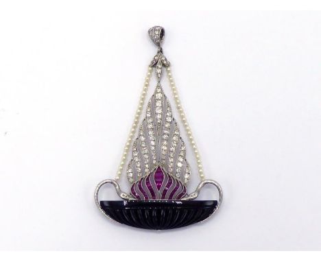 An Art Deco diamond, ruby, onyx and seed pearl pendant, designed as a rising flame of calibre cut   rubies below plumes of pa