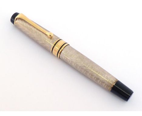 AURORA, Carlo Goldoni, a silver limited edition fountain pen, no 1153/1793, the silver engine turned cap and barrel with gilt