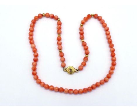 An Italian 18 carat gold and coral necklace, composed of uniform 6.1 mm spherical beads, with gold spacers and clasp, Italian