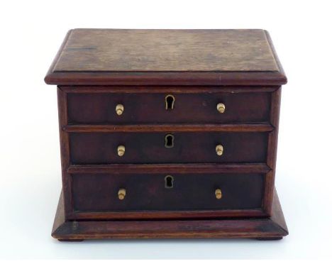 A two compartment tea caddy in the form of a mahogany three drawer chest of drawers with turned ivory knobs. In generally goo