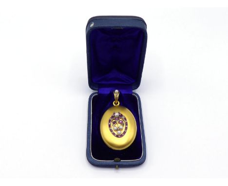 A 19th century Austro-Hungarian gold, ruby, diamond and pearl locket, the oval body of matt gold, set to the centre with a de