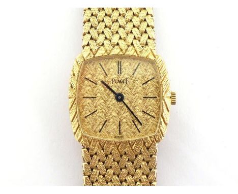PIAGET, a lady's 18 carat gold manual wind wristwatch, the textured square cushion dial with black baton markers and hands, 2