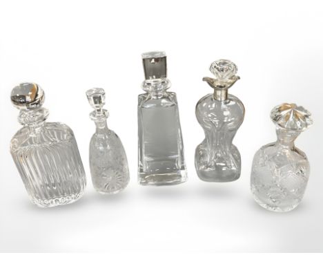 Five cut crystal and glass decanters including a silver mounted decanter, tallest 30 cm  