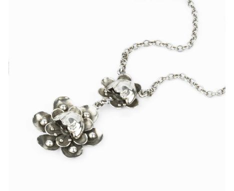 A collection of white metal jewellery, comprising a white metal pendant necklace, designed as two stylised flowerheads, on a 