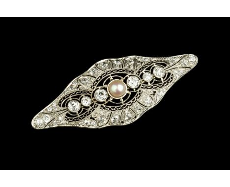 A diamond and half pearl panel brooch, the shaped oval panel with openwork geometric decoration, centred with a half pearl an