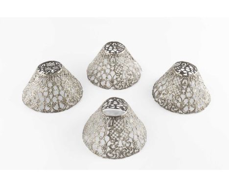 A set of four American silver plated lamp shades, pierced and embossed with scrolling foliage, by Gorham, 14cm wide, and a sm