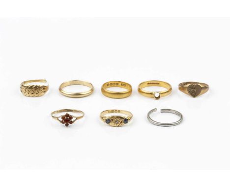 A collection of rings, comprising an Edwardian sapphire and diamond set panel ring, hallmarked for Birmingham 1906, a 22ct go