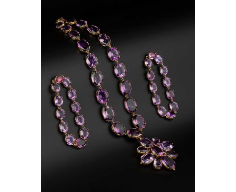 A late 19th century amethyst demi-parure, comprising a rivière necklace, a pair of bracelets and a cross brooch/pendant, the 