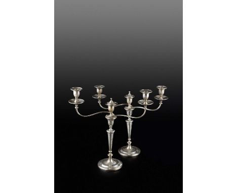 A pair of George III silver three light candelabra, the detachable branches with reeded drip pans, and having faceted taperin