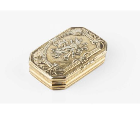 An early 19th century silver gilt snuff box, of rectangular form with canted corners, the hinged cover decorated in relief wi