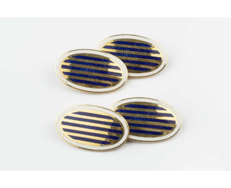 A pair of enamel cufflinks, each oval panel heightened with reeded blue enamel decoration and white enamel borders, on chain-