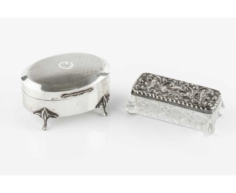 A silver oval trinket box, the hinged cover with engine turned decoration, on shaped legs, by Cornelius D. Saunders &amp; Jam