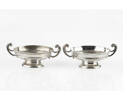 A pair of Edwardian silver twin handled dishes, each on pedestal foot, by William Hutton &amp; Sons Ltd, Birmingham 1907, 16.