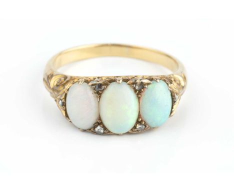 An opal and diamond half hoop ring, the trio of oval cabochon opals spaced by rose-cut diamond points, above a scroll pierced