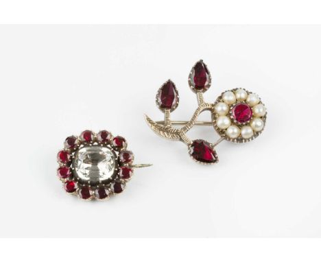 Two 19th century garnet set panel brooches, the first a cluster brooch, centred with a cushion-shaped rock crystal in foiled 