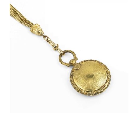 An early Victorian locket pendant, of circular engine-turned form, with hinged compartment and foliate scroll border, the int