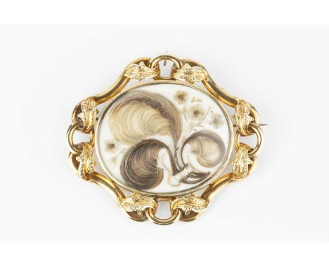 An early Victorian memorial brooch/pendant, centred with an oval glazed compartment containing hairwork spray, within a scrol