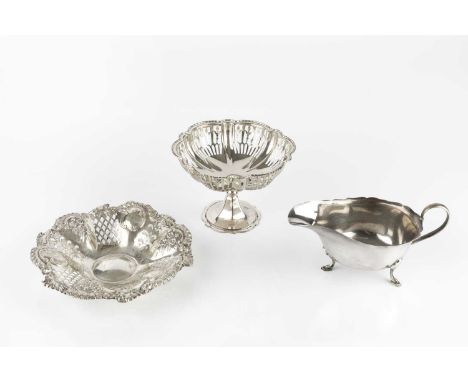 A silver sauce boat, with shaped border, on pad feet, by Mappin &amp; Webb, Sheffield 1935, a silver pierce decorated pedesta