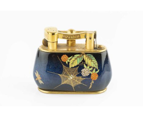 A Dunhill table lighter, the ceramic Carlton ware body decorated with spider's webs and foliage on a blue ground, the gilt me