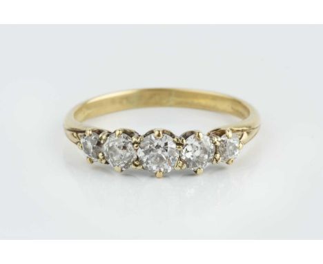 A diamond five stone ring, the graduated old-cut diamonds in claw setting, yellow precious metal mounted, total diamond weigh