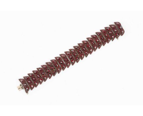 A 19th century garnet panel bracelet, designed as a series of leaf-shaped panels, each with a cluster of circular, oval and p