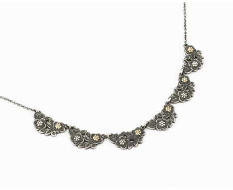 A collection of jewellery attributed to Bernard Instone, comprising a collar necklace, with bi-colour floral and foliate deco