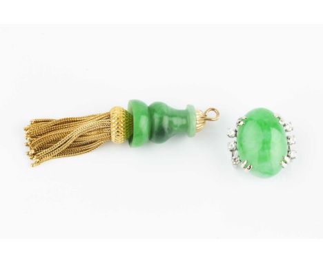 A jade and diamond pendant, the oval jadeite cabochon claw set between trios of round brilliant-cut diamonds, with dual loop 