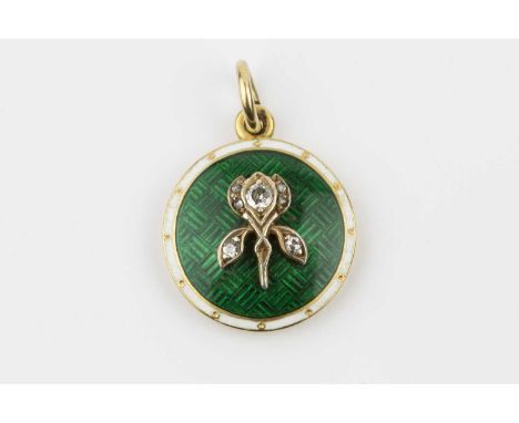 An early 20th century enamel and diamond pendant, the circular panel heightened with a floral motif of transitional, single a