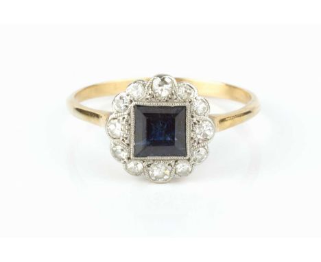 A sapphire and diamond panel ring, the square step-cut sapphire millegrain set within a border of graduated single-cut diamon