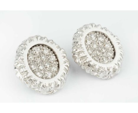 A pair of diamond set ear clips, each shaped oval panel centred with a pavé set cluster of graduated round brilliant-cut diam