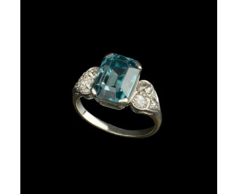 A blue zircon and diamond dress ring, the rectangular step-cut blue zircon in claw setting, between millegrain set shoulders 