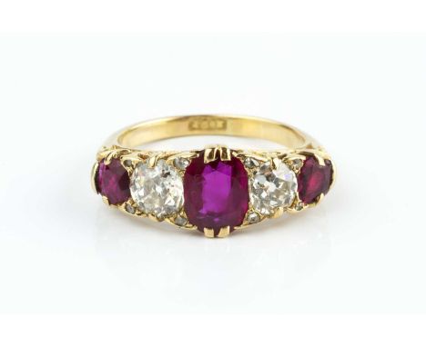 A ruby and diamond five stone ring, alternately set with cushion-shaped mixed-cut rubies and old-cut diamonds, spaced by rose