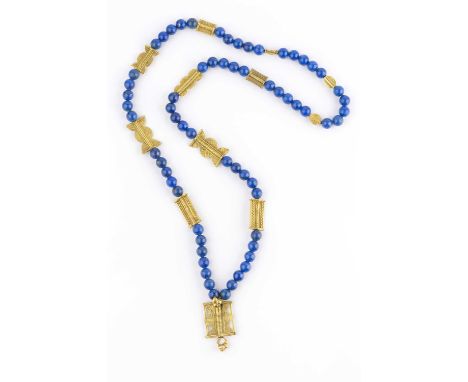 A lapis lazuli bead necklace, the single strand of uniform lapis lazuli beads with shaped gilt metal panel spacers, decorated