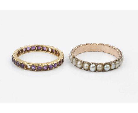 Two antique full hoop eternity rings, comprising a half pearl full hoop ring, and an amethyst full hoop ring, each gold mount