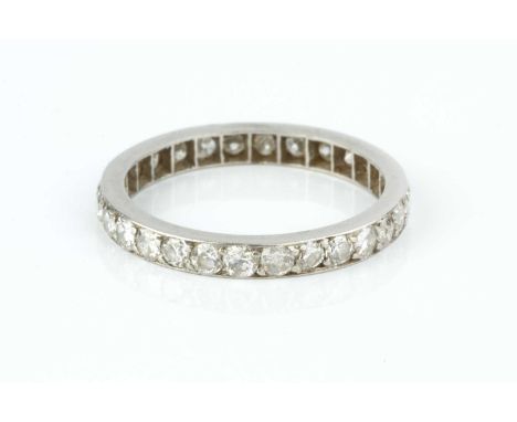 A diamond full hoop eternity ring, set throughout with Swiss-cut diamonds, the white precious metal mount with French dog's h