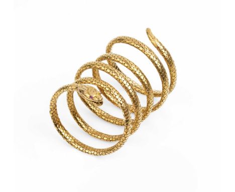 A late 19th century serpent bracelet, modelled as an expandable coiled snake, highlighted with cushion-shaped ruby eyes, sign