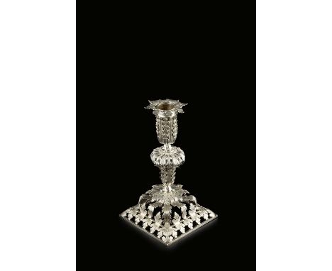 An 18th century silver candlestick, possibly Colonial, cast and pierced with stylised leaves, with engraved decoration, havin