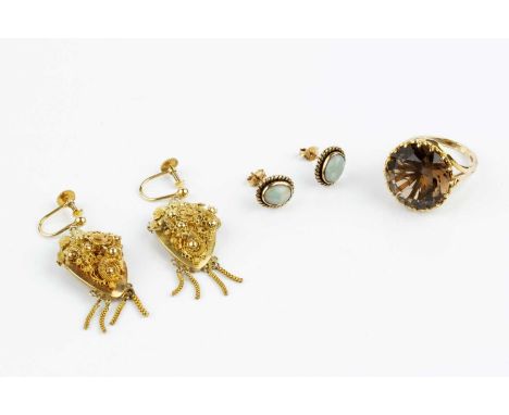 A pair of ear pendants, each shield-shaped panel applied with a cluster of flowerheads, leaves, beads and wirework scrolls, s