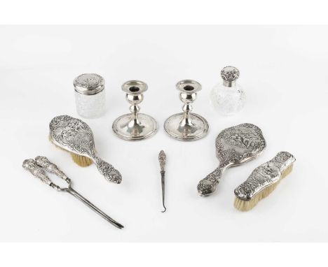 A matched Edwardian and later silver dressing table set, repousse decorated  with a musician and other figures in a garden, c