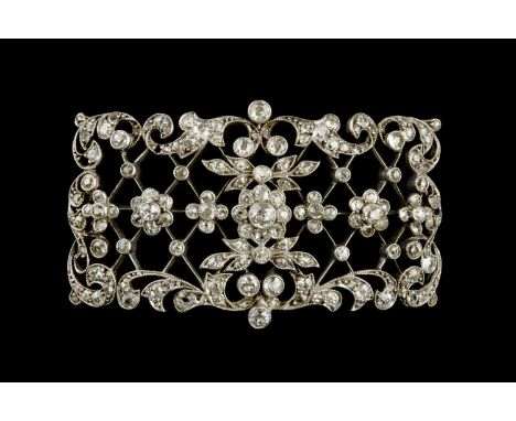 A late 19th/early 20th century diamond set panel, the shaped rectangular convex panel designed as an openwork lattice highlig