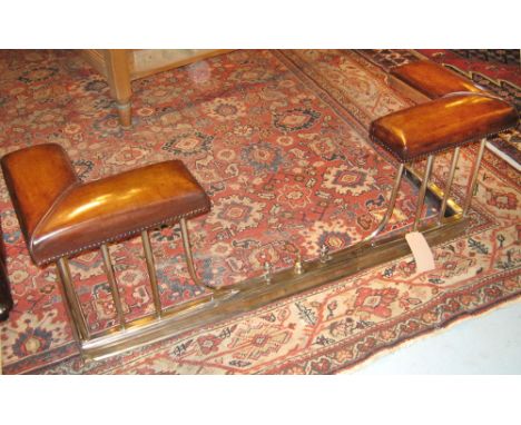 ADJUSTABLE CLUB FENDER, early 20th century button tan hide seat pads on an extending silvered metal balustrade support, 44cm 