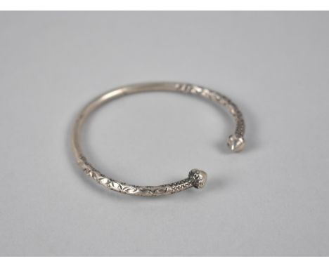 An Ethnic White Metal Bangle, Hammered Decoration and Cone Finials, 21.5gms 