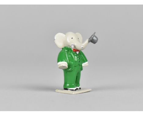 A Cold Painted Miniature Study of Babar the Elephant Modelled Standing with Trunk Carrying Hat, 3cm high 